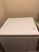 Top view of white chest freezer with flat lid and side handle.