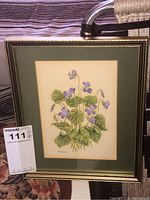 Framed watercolour painting of purple flowers with signature visible, includes size and detail of frame.