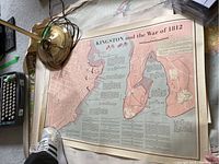 Colour historic and regional maps including Kingston and War of 1812, regional Quebec maps, and a world map with some tears and wear noted.