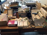 Full view of desk with multiple boxes and organizers holding various paper goods, cards, envelopes, and office accessories.