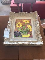 Frontal view of the framed oil painting showing flowers and fruit