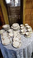 Full set arranged on a table showing multiple dinnerware items including plates, bowls, cups and saucers