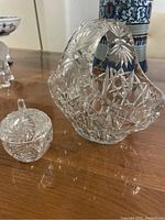 Side angle showing the cut crystal basket and petite covered container together, highlighting detailed star and geometric cuts.