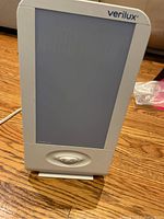 Front view of Verilux Happy Light therapy lamp showing its comfort lens and control switch