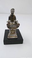 Front view of the sterling silver Judaica sculpture showing figure at Torah scroll with Star of David on pedestal.
