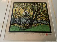 Close-up of linocut image showing tree branches, grass and background color fields