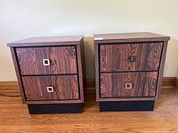 Pair of two-drawer bedside tables with faux rosewood finish and black bases shown from front.