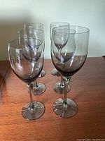 Six Orrefors vintage crystal wine glasses arranged on a wooden surface, showing two rows of three glasses each, highlighting their shape and clear crystal finish.