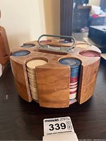 Front side view of wooden carousel filled with poker chips in red, blue, and beige.