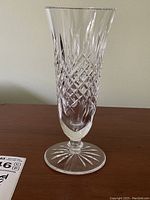 Side view of Waterford crystal vase on a wooden surface showing cut pattern and shape