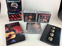 Overview of various CDs and boxed sets including Bob Marley and Pink Floyd commemorative sets alongside other classical and pop CDs.