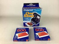 Photo showing the Polaroid OneStep 600 camera box and two unopened boxes of Polaroid 600 instant film.