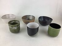Overview of the six vintage pottery items showing different angles and colors.