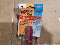 Photo of Shop Fox D2725 36 inch T-Slot Track packaged with branding and usage information visible.