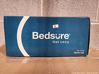 Blue and white boxes labeled Bedsure indicating microfibre quilt set.