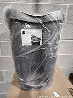 Umbra Brim trash can in plastic wrap showing product label