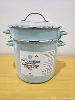 Front view of the teal Martha Stewart stock pot showing label and overall condition.
