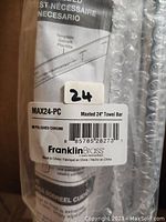 Image shows the product packaging label with product name, model number, and brand Franklin Brass. Indicates polished chrome finish and 24 inch towel bar.