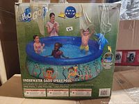 Boxed H2O Go Underwater Oasis Spray Pool with images of children playing in the pool and illustrated underwater characters on the pool sides.