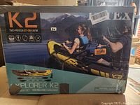 Photo of the Intex Explorer K2 kayak packaging showing two people kayaking on a lake, with branding and product details.