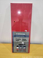 Photo of boxed ITY International wooden floating shelf. Box red with product info and price label.