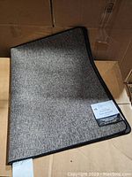 Photo of Mainstays Indoor Accent Mat folded in a box showing texture and size.