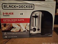 Box of Black & Decker 2-slice toaster showing product details and features.
