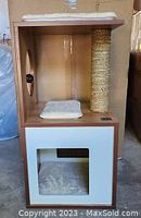 Front view of Catit Vesper small cat house showing walnut wood finish, squared white front panel with entrance, scratching post, and cushions.