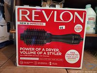 Original packaging box of the Revlon One Step Hair Dryer and Volumizer showing product image and key features on the front face.
