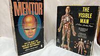 Side-by-side view of the original game boxes of Hasbro Mentor and Renewal The Visible Man.