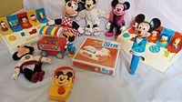 Overview of all Disney and Mickey Mouse toys including dolls, radios, corn popper and boxed game.