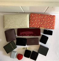Photo of all jewelry boxes arranged on surface showing variety of sizes, colors, and styles