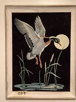 Front view of framed velvet painting showing the duck landing scene