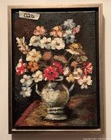 Frontal view of the framed original oil painting showing the floral arrangement with textured paint and signature.