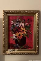 Front view of the small floral impasto painting in gold wood frame, showing colorful flowers in dark vase on red background.