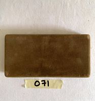 Closed brown velvet jewelry box, plain with no visible markings or logos