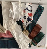 Overview of scarves, gloves, and decorative rosette headwear in multiple colors and patterns.