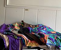 Overview of vintage 1980s one-piece swimsuits in various colors and patterns.