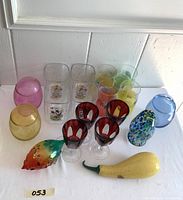 Various colorful glasses and murano ornamental glass including Mickey Mouse and fruit designs