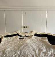 Top view of three vintage sequin and bead beaded blouses laid flat, showing the sequins and part of the back zippers.