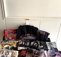 Overview of folded T-shirts stacked against wall