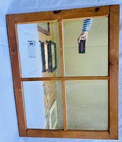 Front view of pine window frame mirror showing all four mirror panes and wood finish.