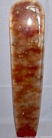 Close up of the glass blade showing brown and amber mottled glass with frosted texture and bubbles.