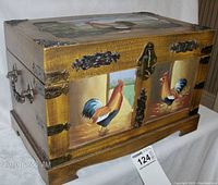 Side view of wooden box with hand painted rooster image, brass fittings, and latch.