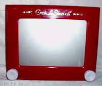 Front view of the red Etch A Sketch drawing toy showing the silver magic screen, two white control knobs, and gold 'Etch A Sketch' branding on the top frame.