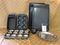 Front angle shows all baking pans arranged for viewing their shapes and sizes.