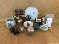 Full view of assorted knick knacks including honey bear, plates, jars, frosted glass cup