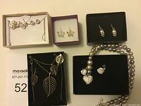 Image showing assorted Avon jewelry including earrings, necklaces, and bracelet boxed for gift giving