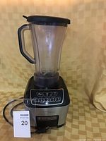 Full view of the blender, showing the pitcher with handle and lid, control panel with multiple buttons on the base.