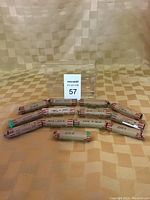 Photo showing 13 rolls of Canadian pennies wrapped in paper and labeled with handwritten dates ranging from the 1920s to 2011.